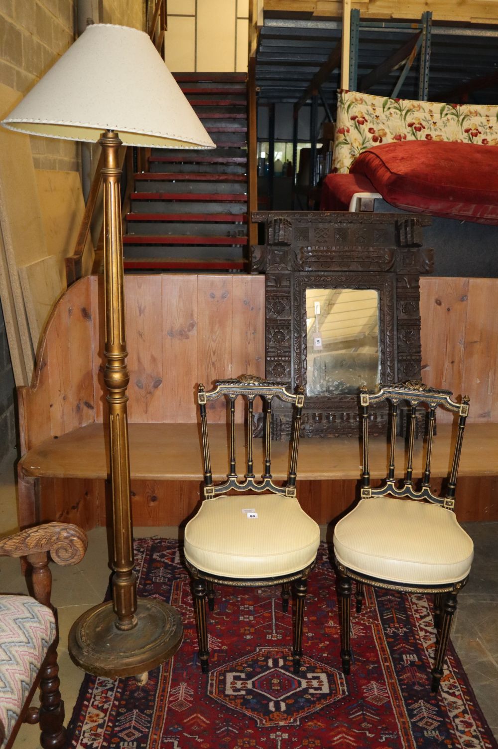 A pair of Victorian ebonised parcel gilt side chairs and a standard lamp